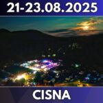 a city at night with a hill and trees